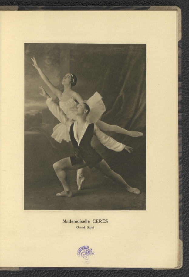 Ein Schwarz-Weiß-Foto eines Mannes und einer Frau in Ballettkleidung, der Mann trägt ein weißes Tutu und die Frau ein rosafarbenes Kleid, tanzt anmutig in perfekter Synchronisation mit Armen und Beinen verschlungen.